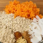 Grated carrots, oats, and spices arranged in a bowl, realistic and warm lighting.