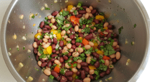 Mixing ingredients for dense bean salad